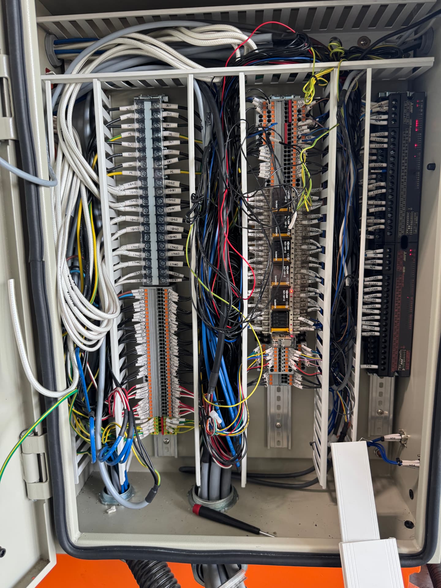 After: same panel after service — cleaned wiring, labeled terminals, and organized control devices