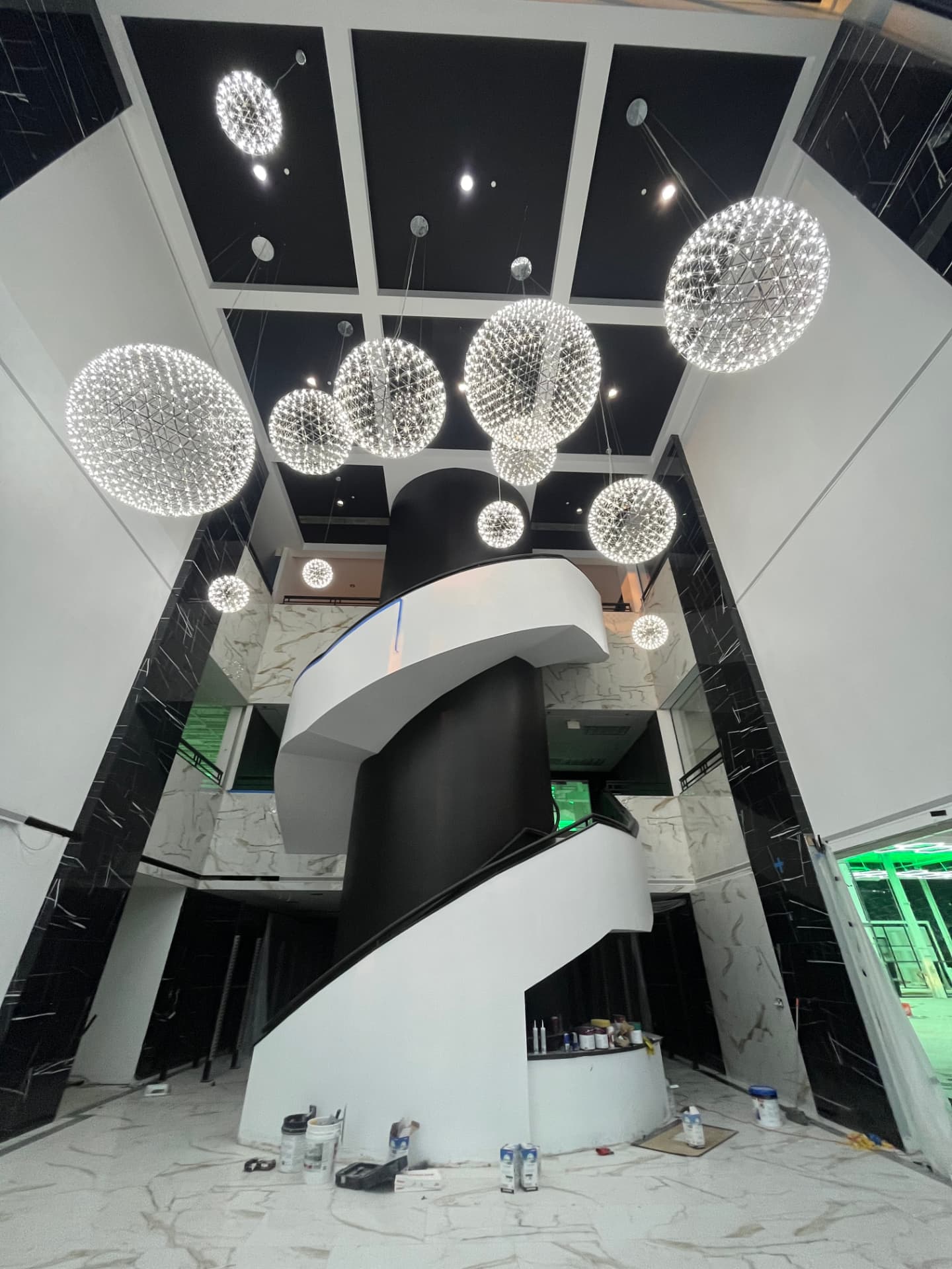 Two-story facility lobby with LED sphere pendant fixtures over a staircase